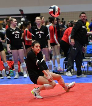 Athletes performing volleyball defensive moves in a synchronized training sequence on a court with red and blue mats.