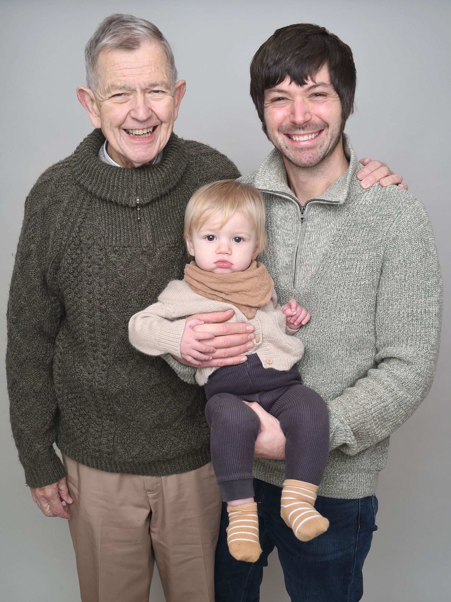 Three generations of men pose in family photograph on light grey background. Picture by Abigail's Studio, High Wycombe
