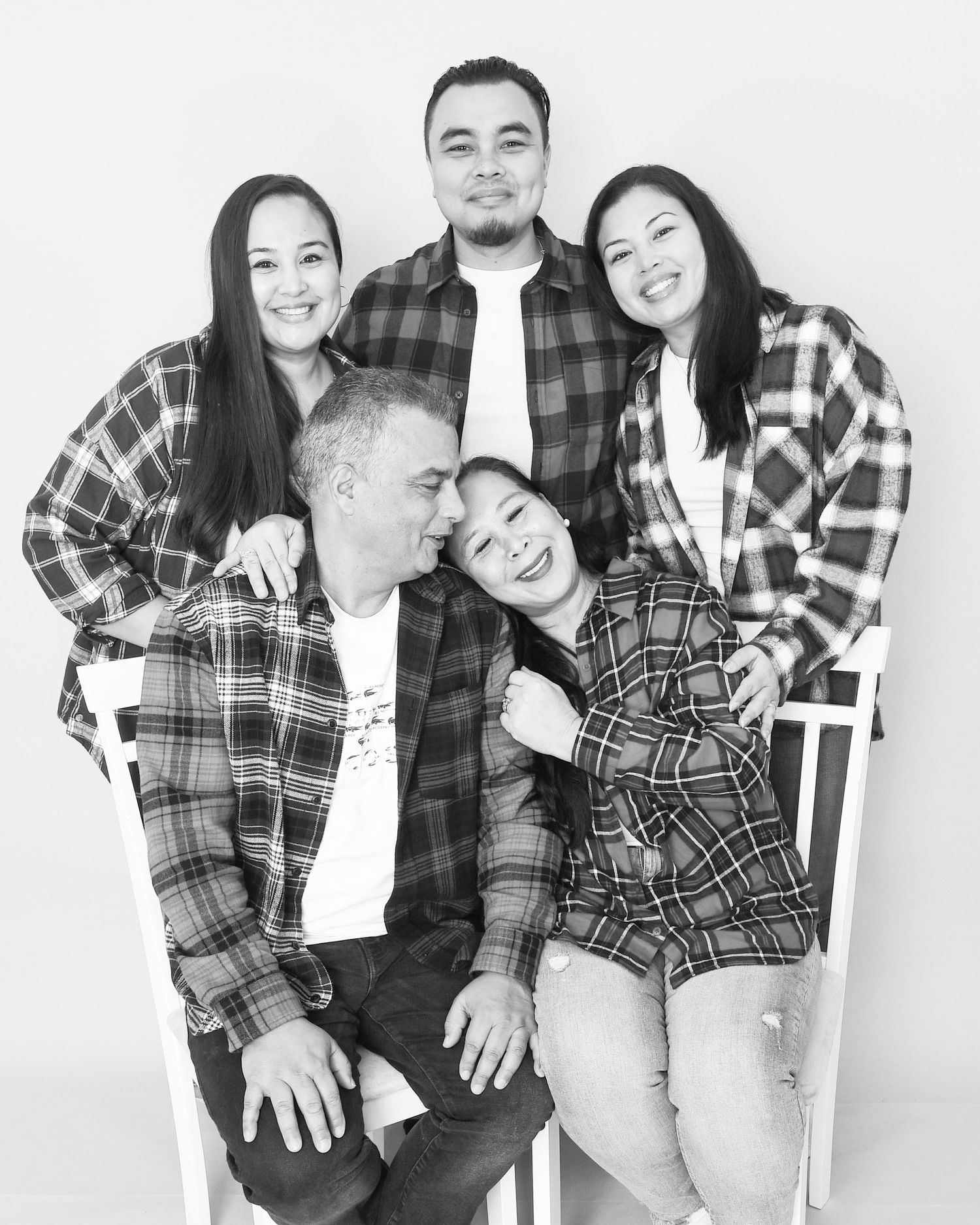 A black and white portrait of a family captured by Abigail's Studio, showcasing their unity and love in High Wycombe.