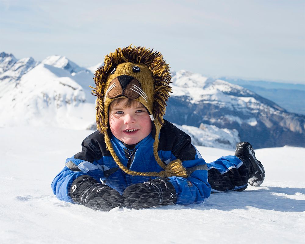 A young boy enjoying the snow, photographed by Abigail's Studio, a family photographer based in High Wycombe.