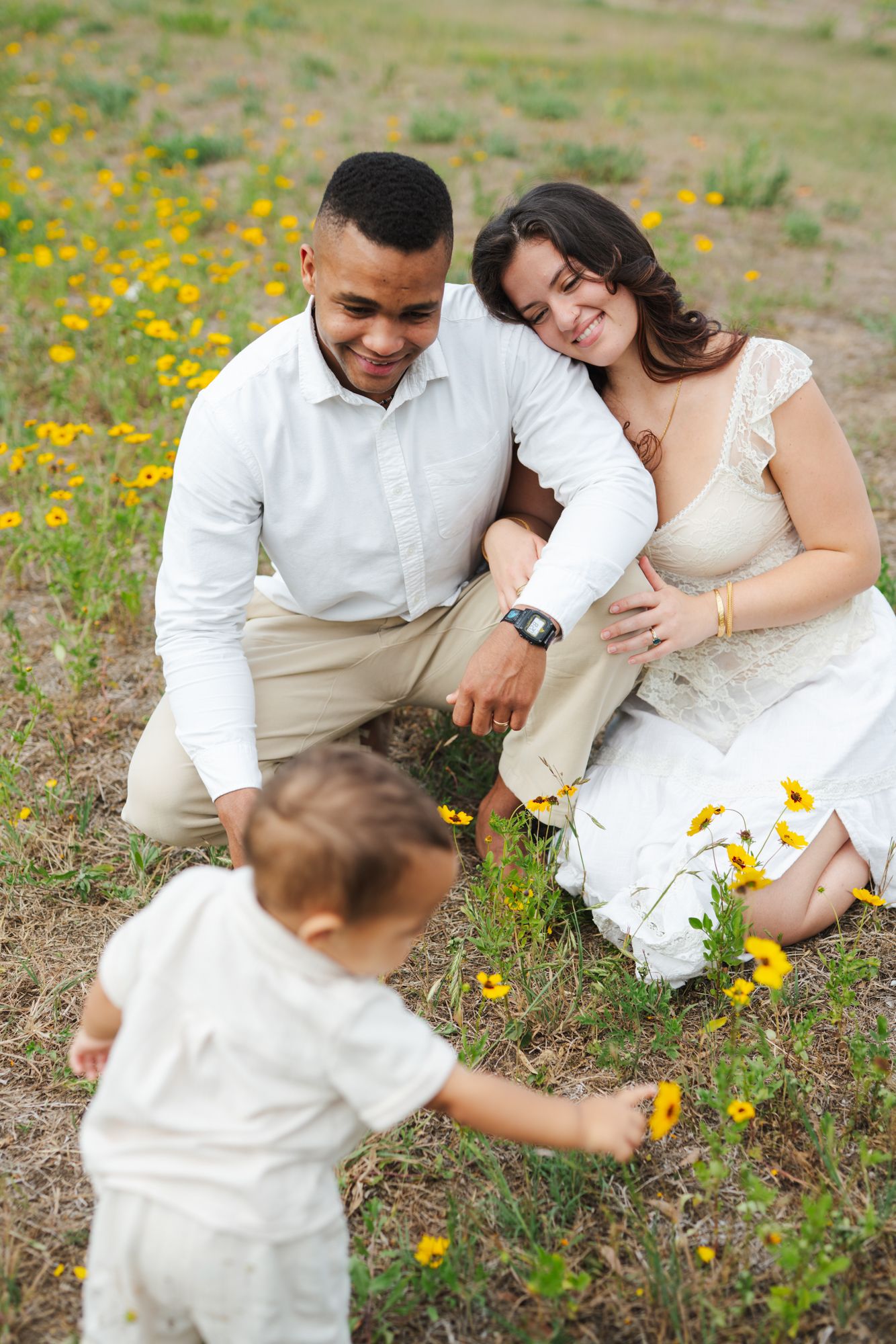 Photo of a mother and father looking at their son