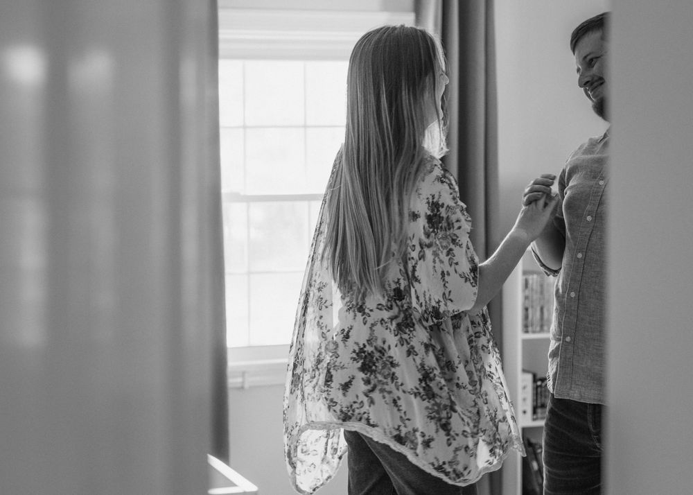 Hannah and David dancing in nursery during their in-home maternity session in Flint, Michigan