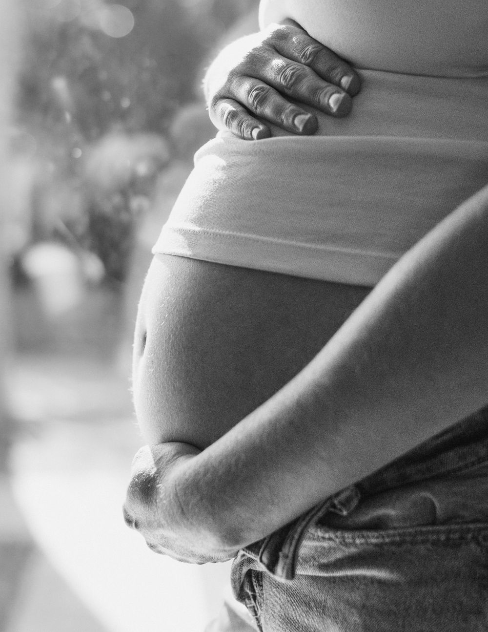Hannah softly lit, black and white, pregnant belly in-home maternity session in Flint, Michigan