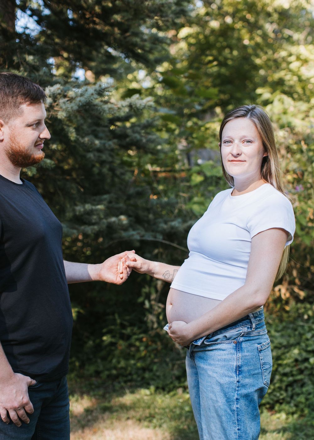 Hannah and David naturally posed during outdoor portion of lifestyle maternity session in Flint, Michigan
