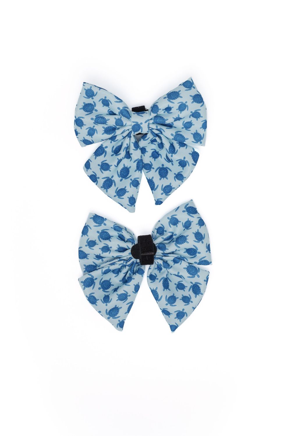 Two blue and white floral print fabric hair bows on a white background.