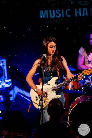 Young female guitarist plays white Stratocaster at The Gem Music Hall Spring City.