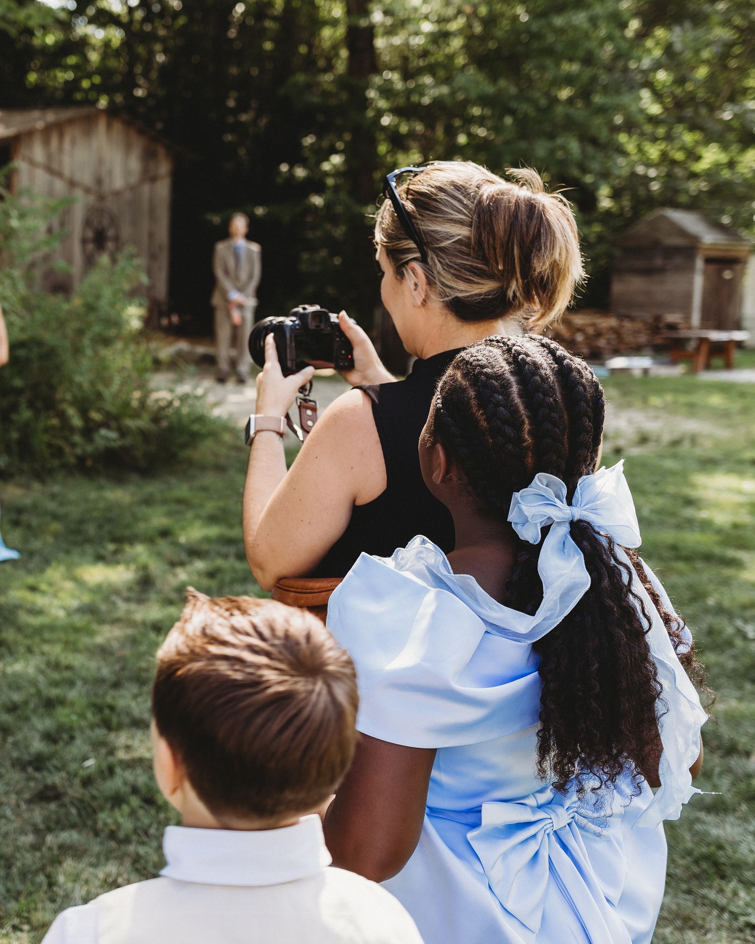 Behind-the-scenes photo of Maine wedding photographer Chelsea Gallagher photographing a couple on their wedding day.