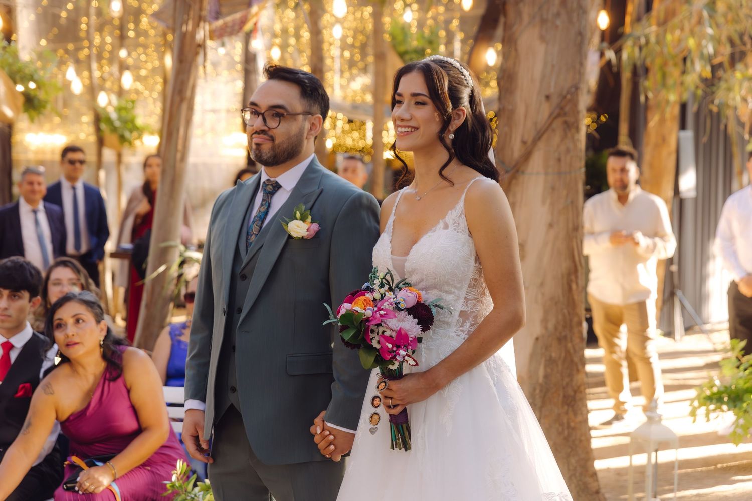 Bride and groom walk down the aisle at an outdoor wedding ceremony.