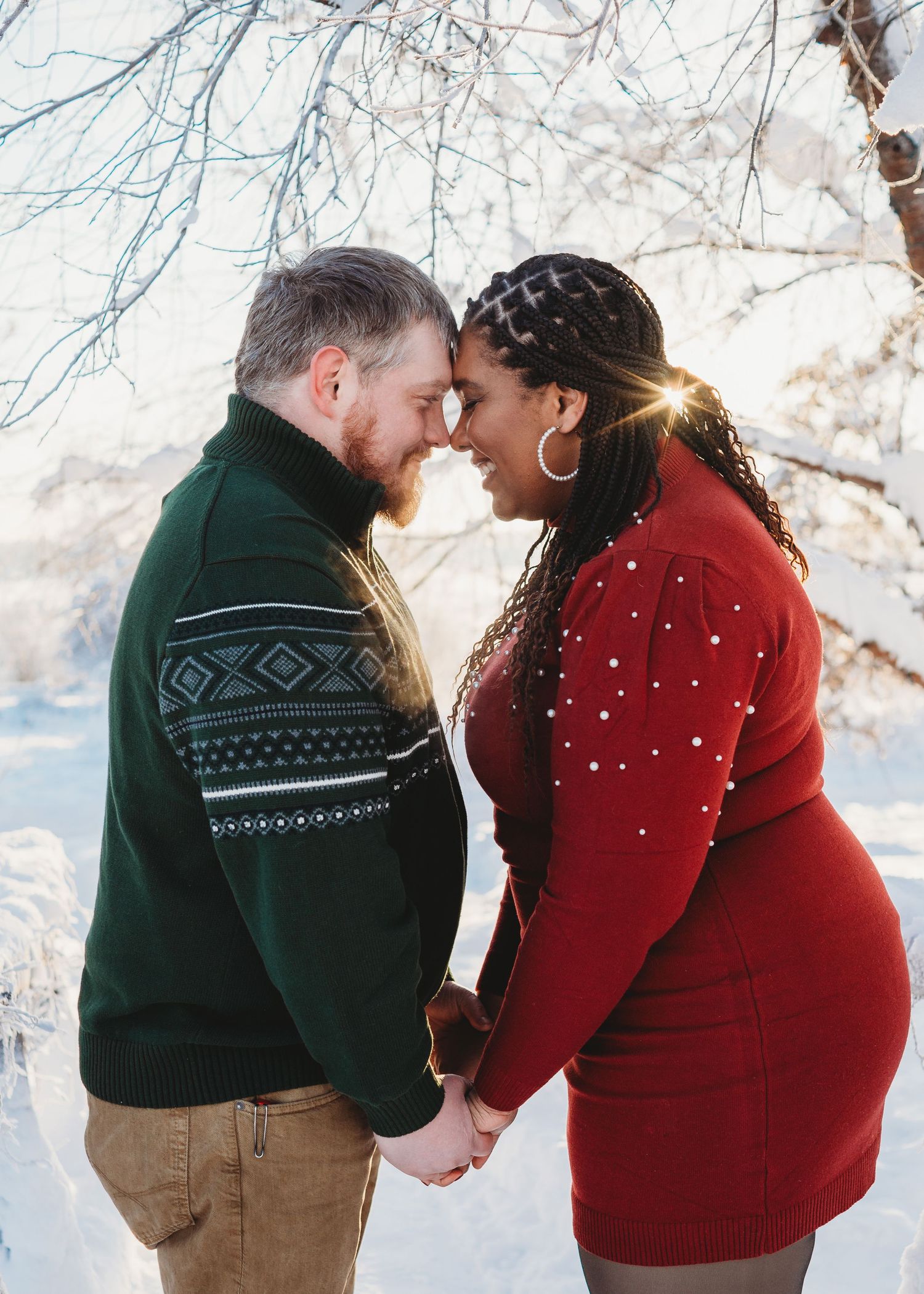 Engaged couple standing together outdoors in winter during an engagement session