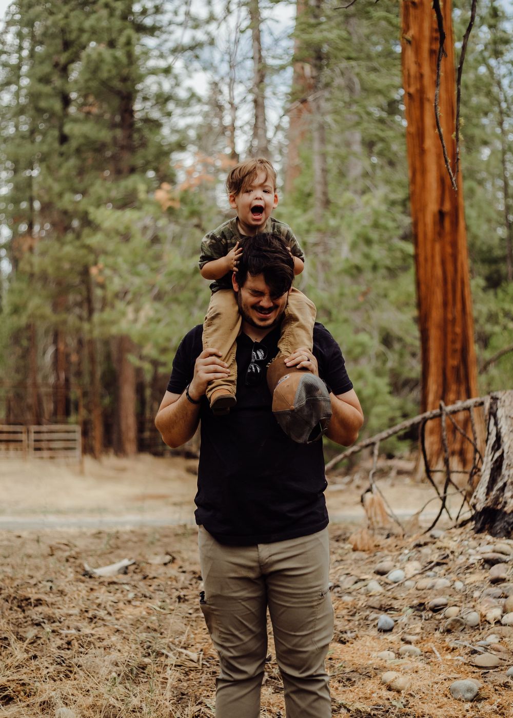 A father carrying his young son on his shoulders
