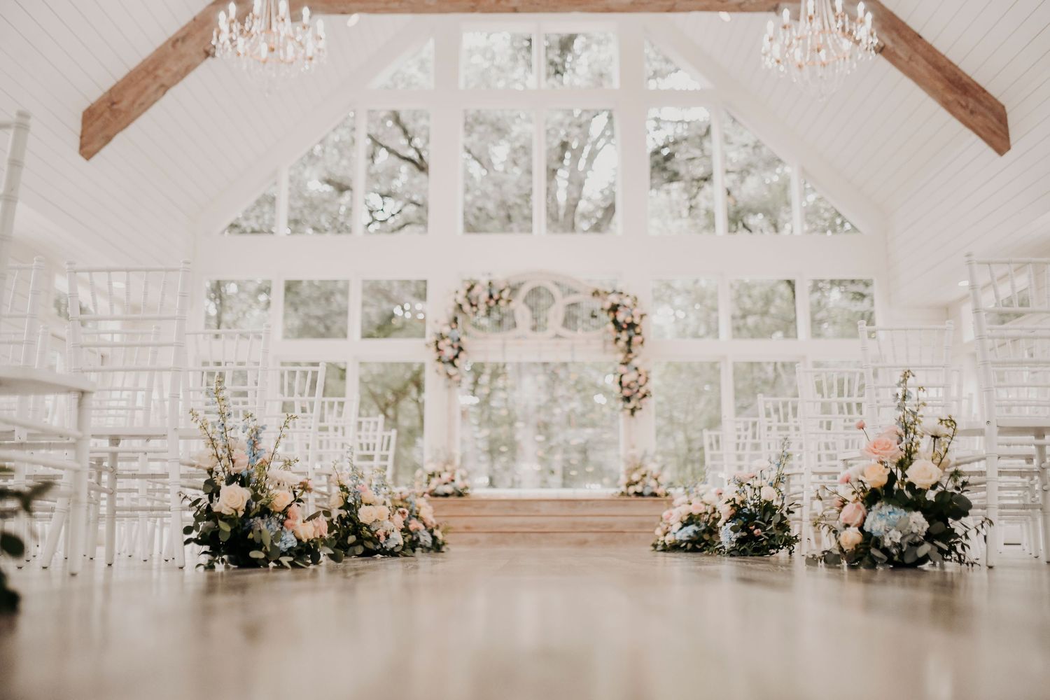 Romantic French Farmhouse wedding ceremony decorated with soft pastel floral arrangements