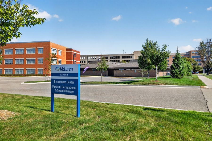 McLaren Wound Care Center physical occupational and speech therapy brick building exterior with blue signage and green lawn.