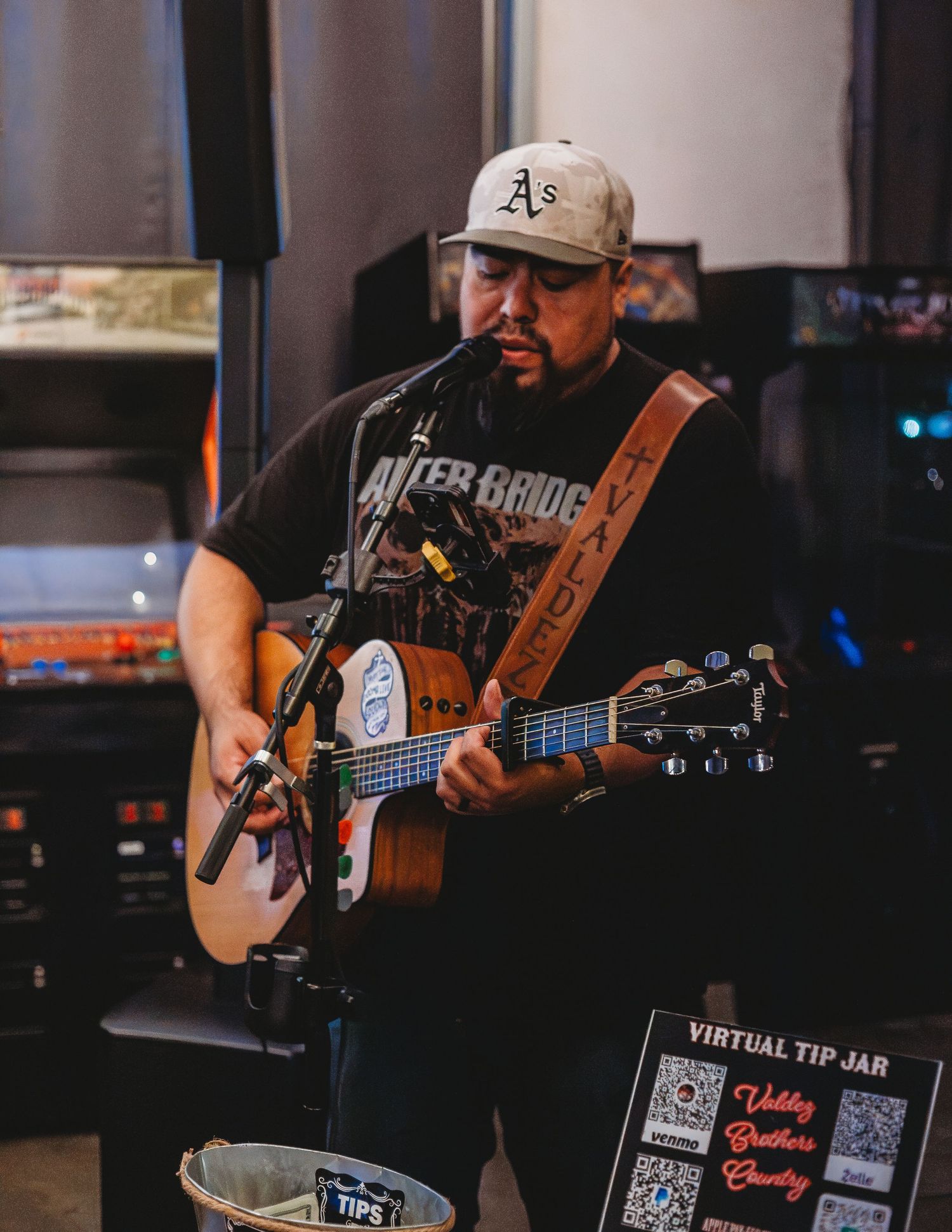 Musician playing guitar in a brewery taproom