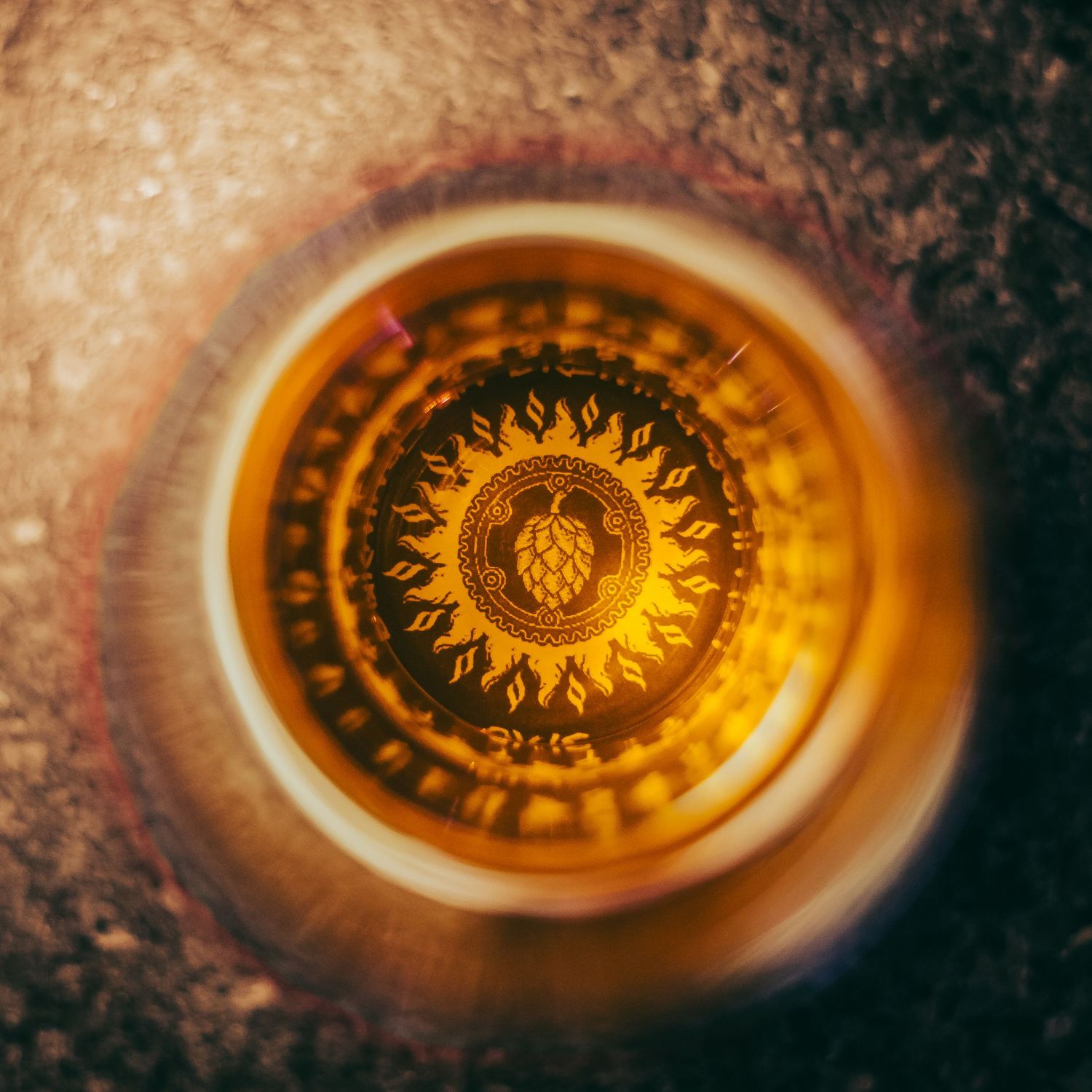 Burning Sun Brewery logo shot top-down through a beer glass