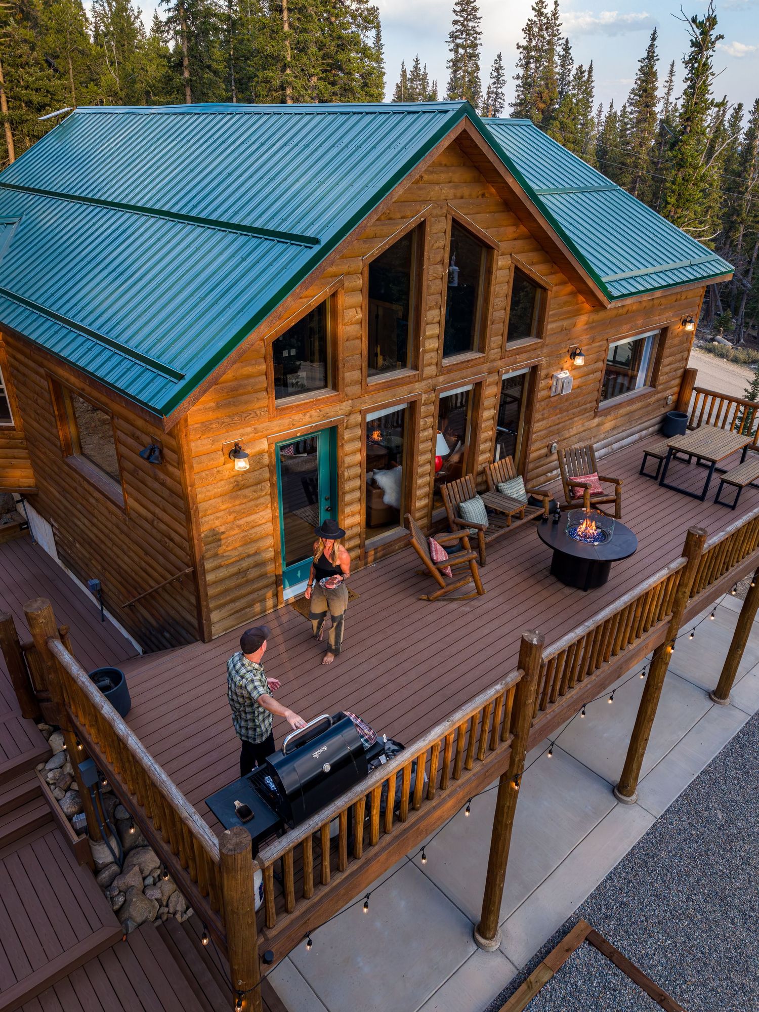 Aerial view of a couple grilling at the short term rental property, Camp Wildwood in Fairplay, CO.