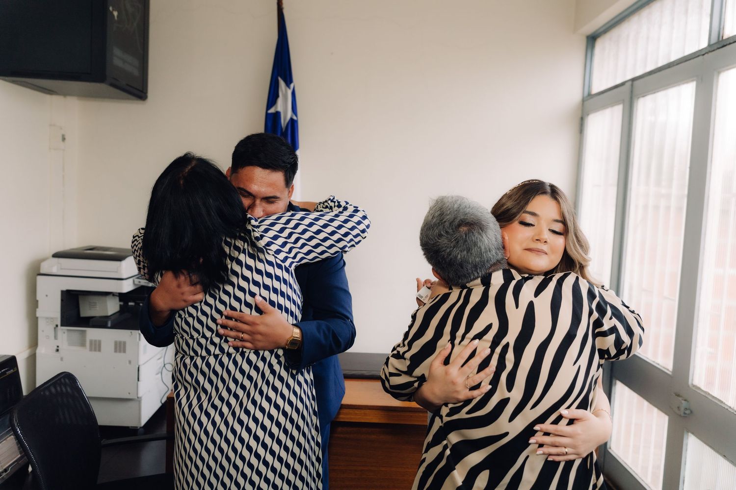 Wedding guests embrace the newlyweds in congratulatory hugs after civil ceremony in Chile.