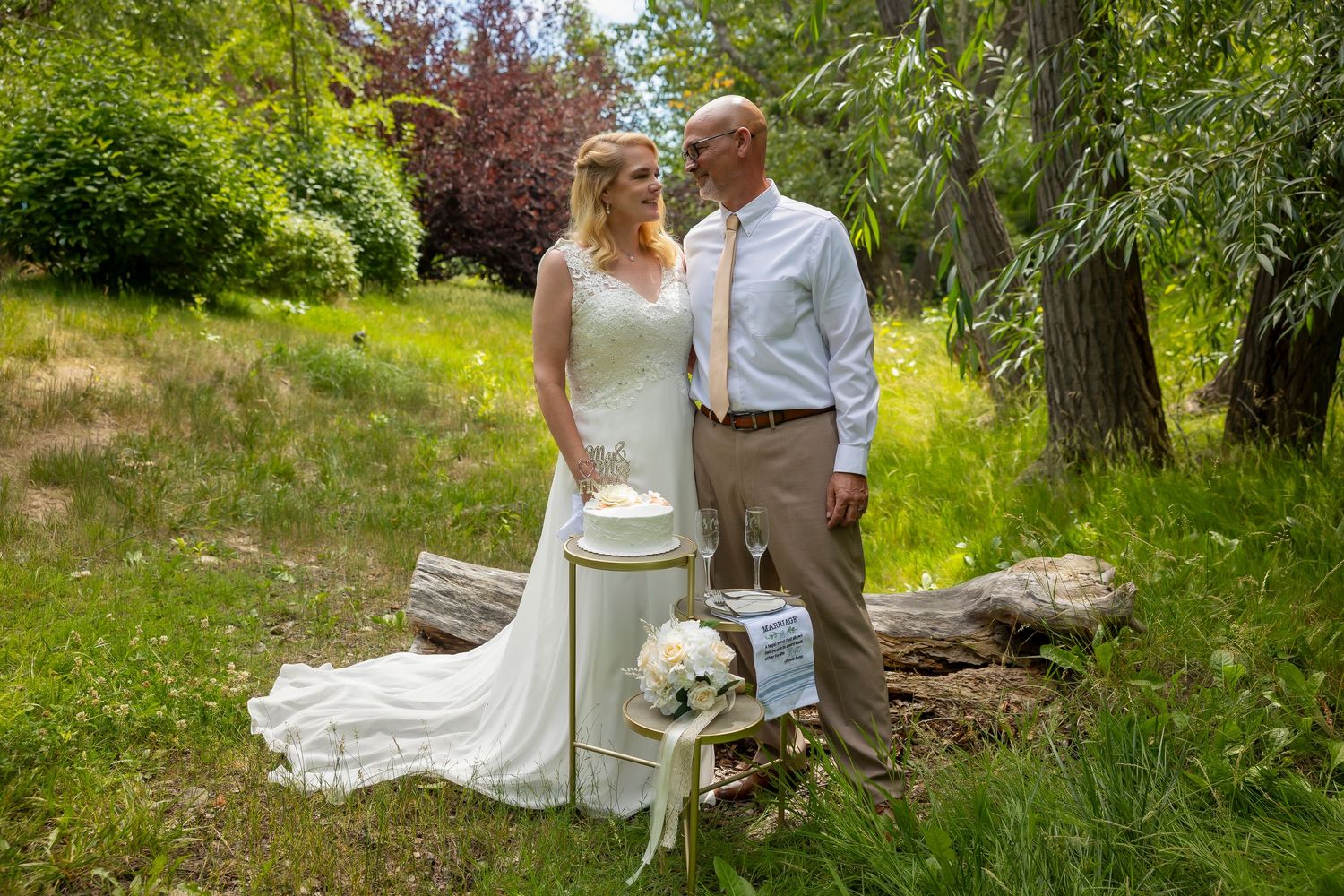 Elopement Boise River bride and groom standing with cake after saying I Do ©Milestones Studios LLC