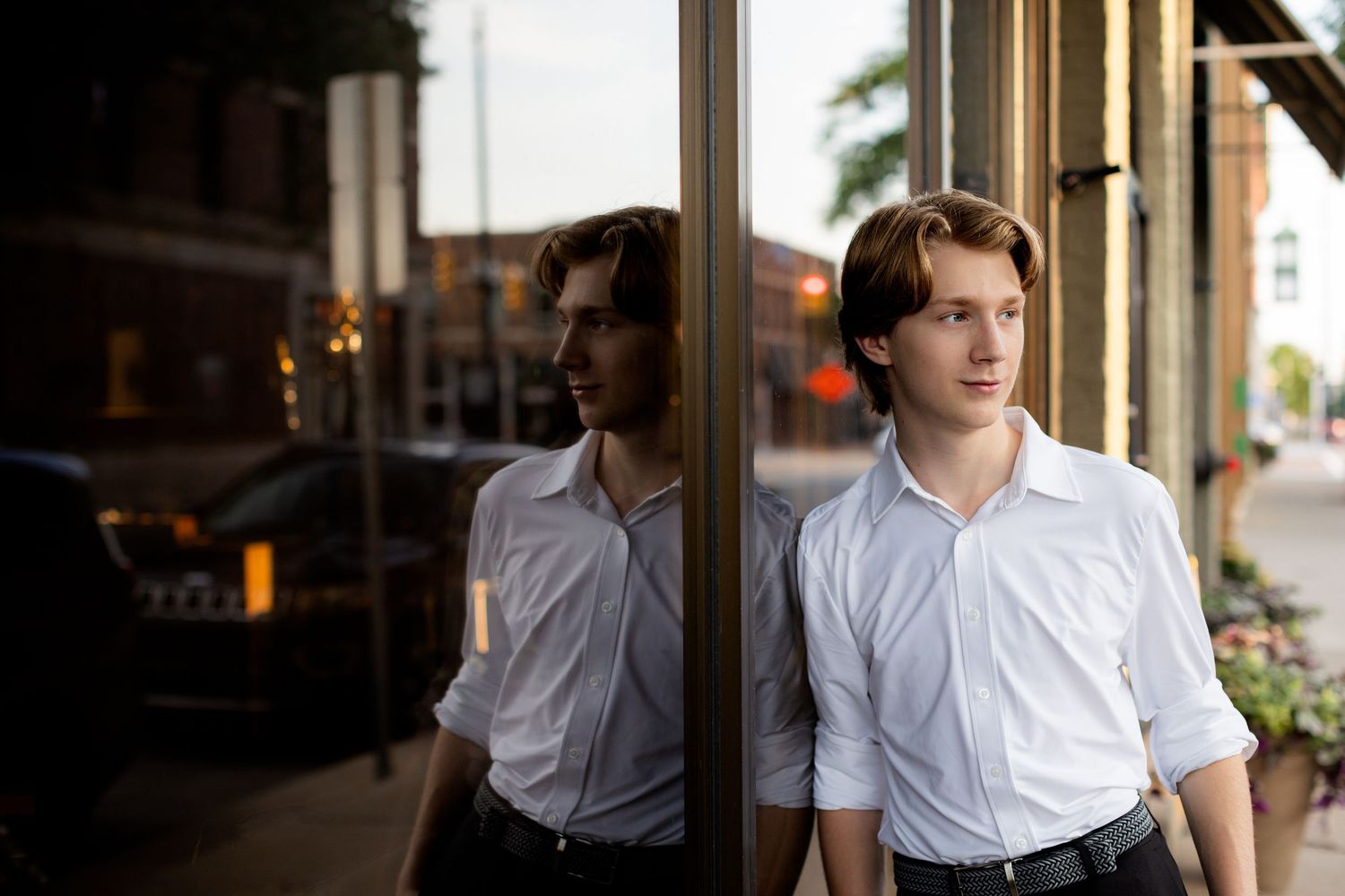 Senior boy photo during sunset in downtown Howell, MI; urban vibe for senior guy with style by Brighton, MI photographer
