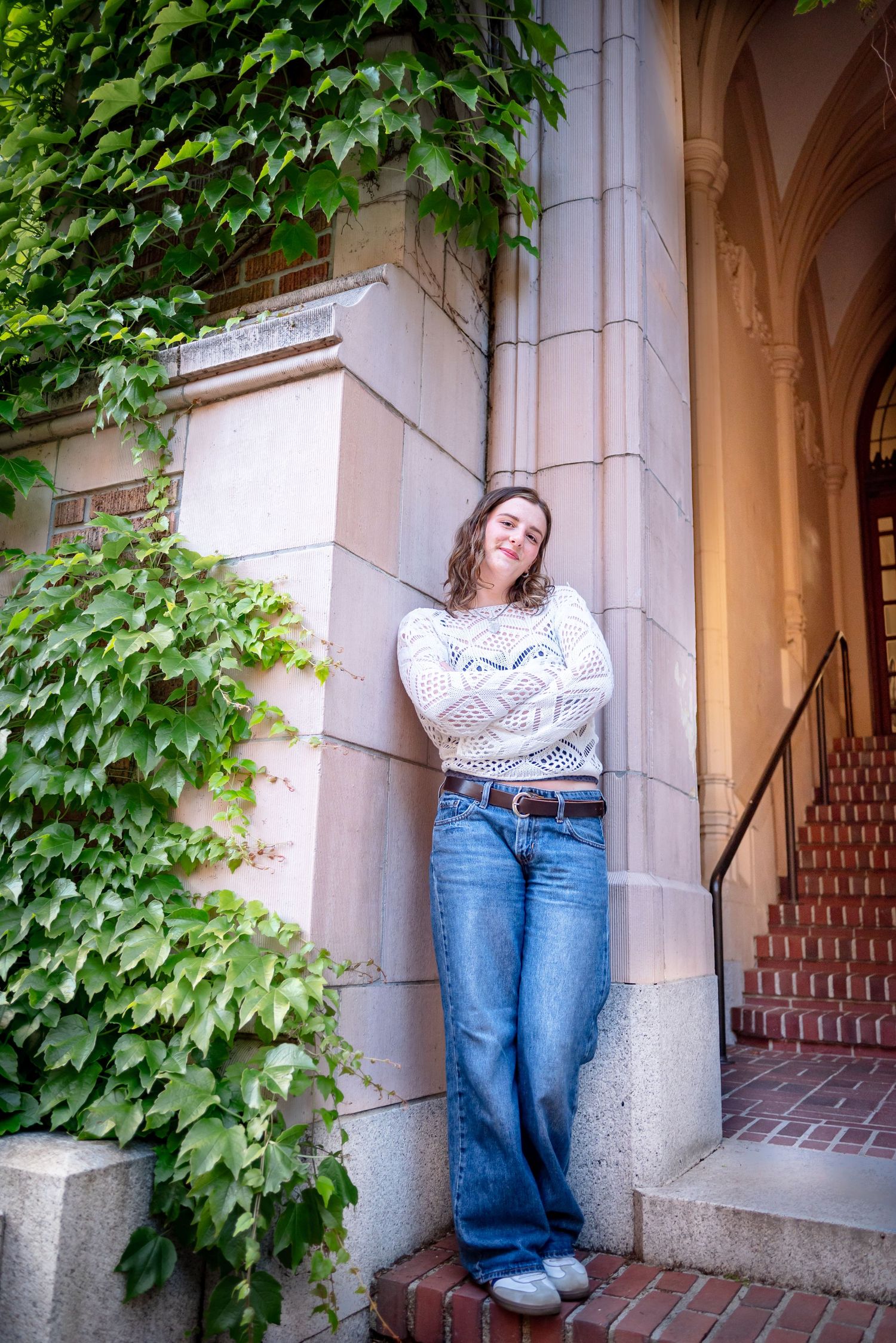 Graduation portrait at the ivy-covered entrance of Miller Hall at the University of Washington