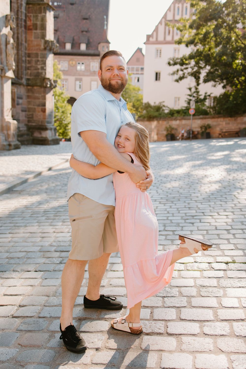 Family hugging and smiling during Nuremberg family photoshoot at St. Seebaldkirche