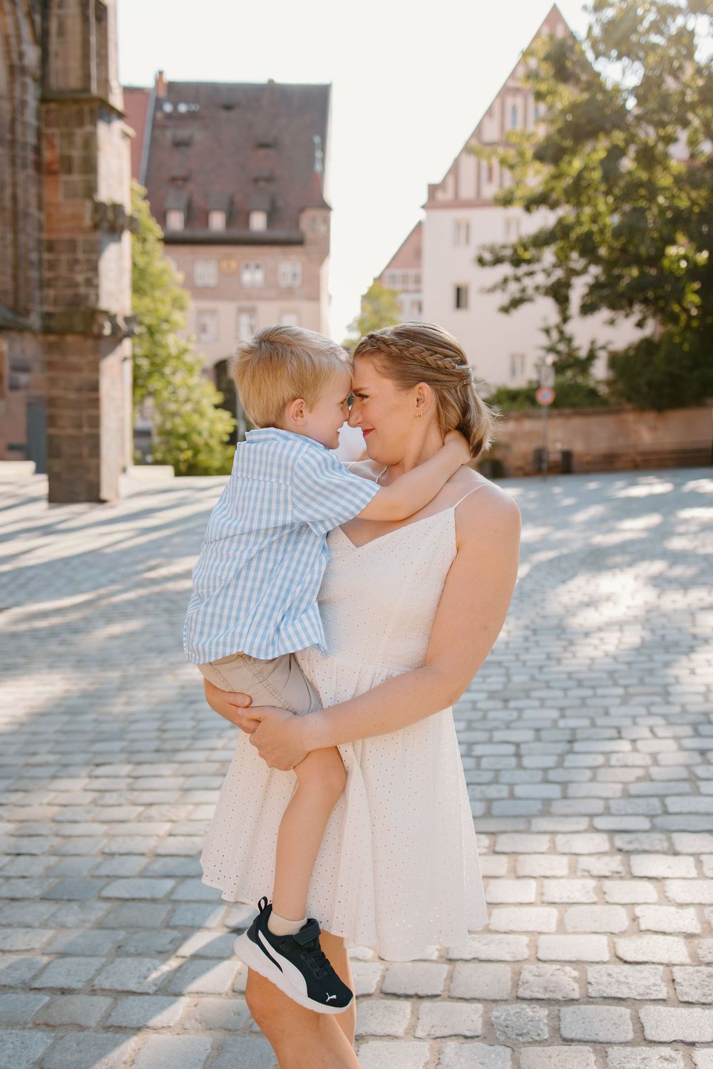 Family hugging and smiling during Nuremberg family photoshoot at St. Seebaldkirche