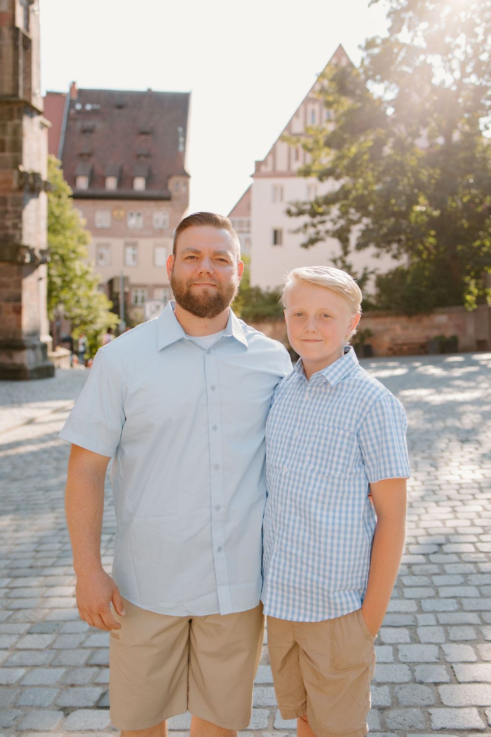 Family hugging and smiling during Nuremberg family photoshoot at St. Seebaldkirche
