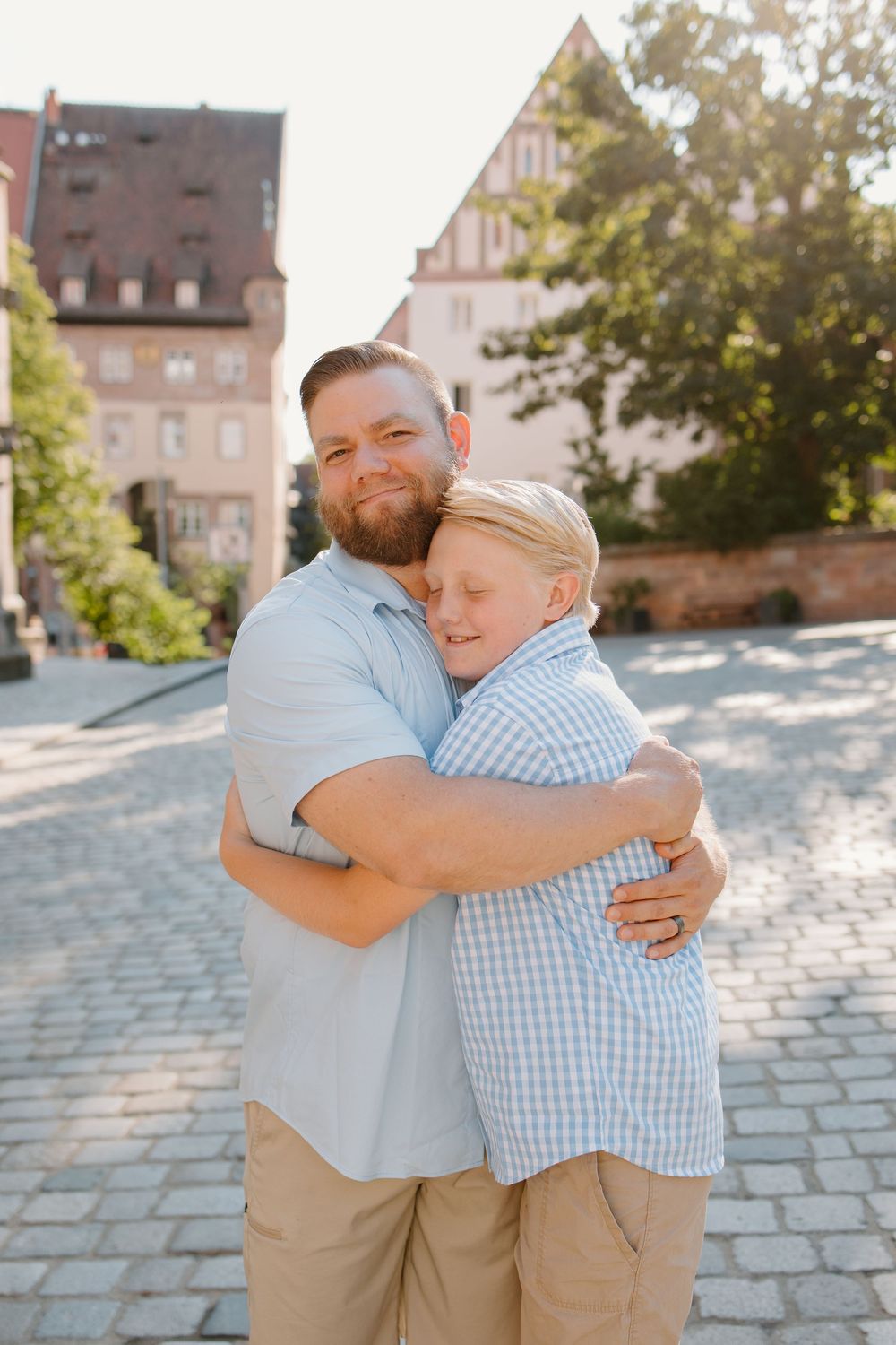 Family hugging and smiling during Nuremberg family photoshoot at St. Seebaldkirche