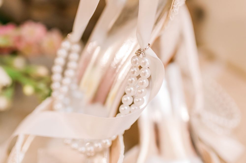 Elegant bridal heels adorned with pearl jewelry displayed for a wedding day.