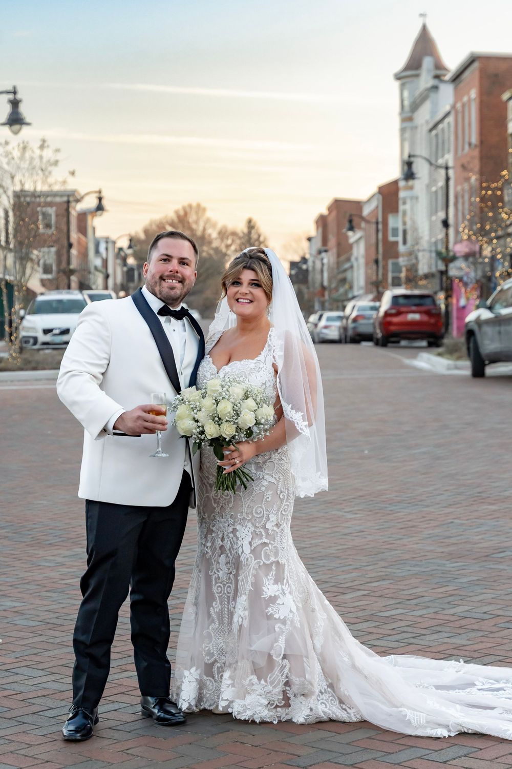 Bride and groom portrait at sunset, urban downtown setting with a cobblestone road