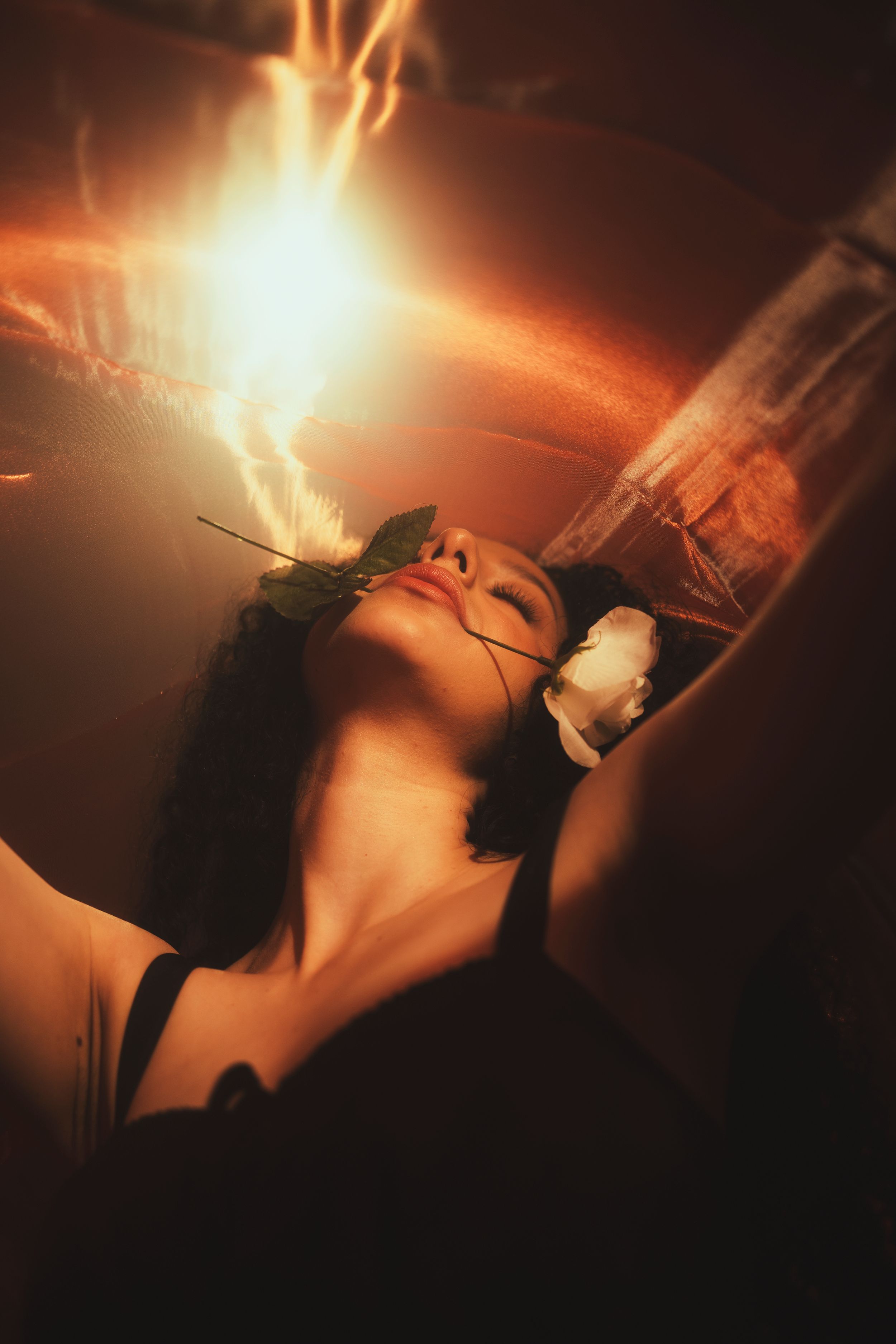 Cinematic portrait of a woman illuminated by dramatic orange light with creative motion blur