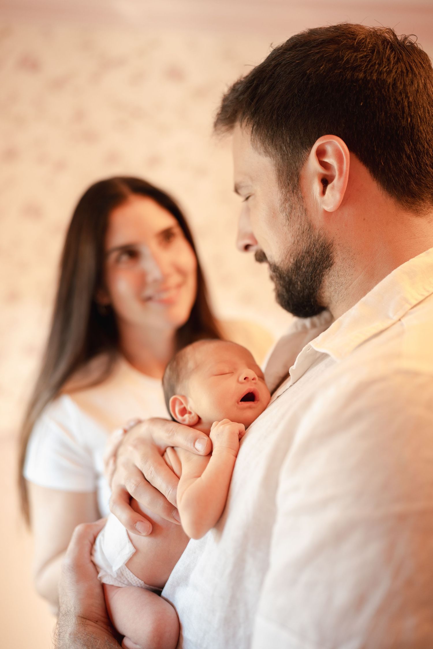 A series of intimate photos showing tender moments between a mom and dad with their newborn baby