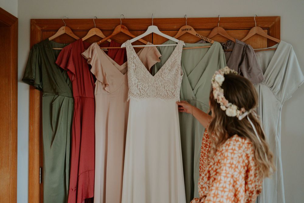 bride admires her and her bridesmaids wedding dresses