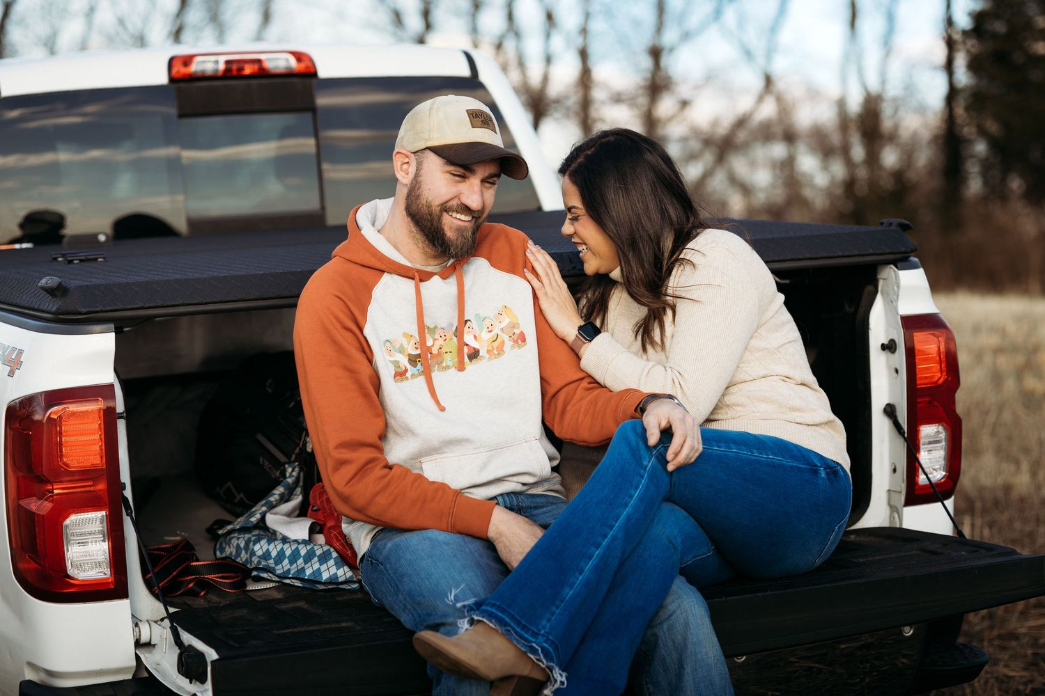 Brayden and Aaliyah laughing together on the tailgate during their Stranger Session in Louisville, Kentucky.