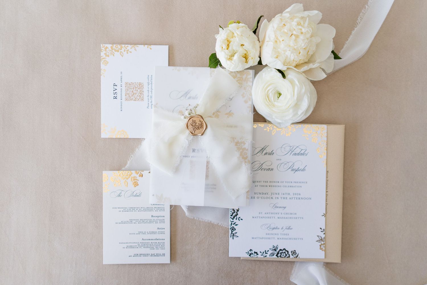 Elegant wedding invitation suite with white peonies, wax seal, and ribbon on a neutral background.