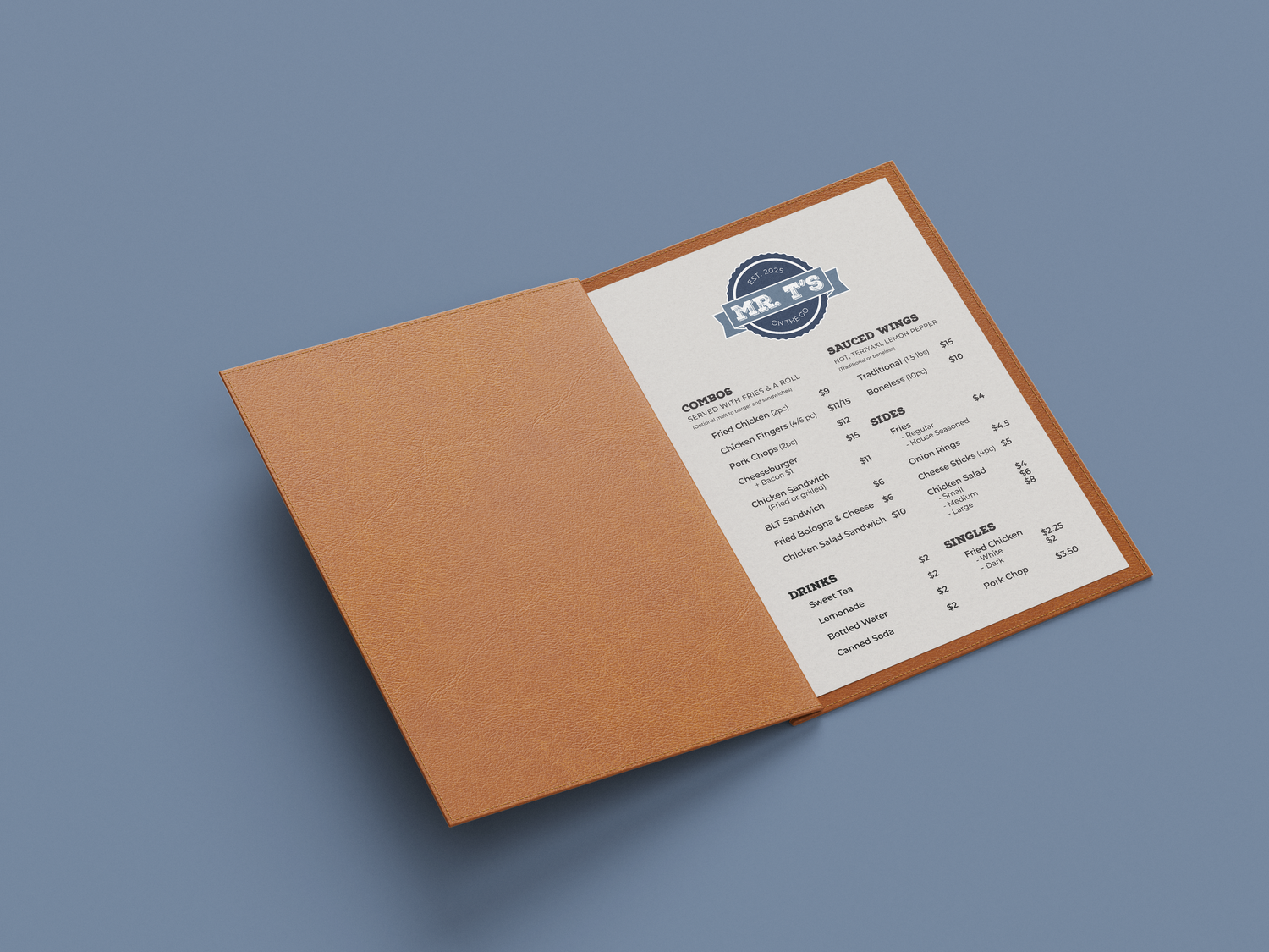 White spiral-bound recipe book with colorful fruit illustrations on the cover against green background.