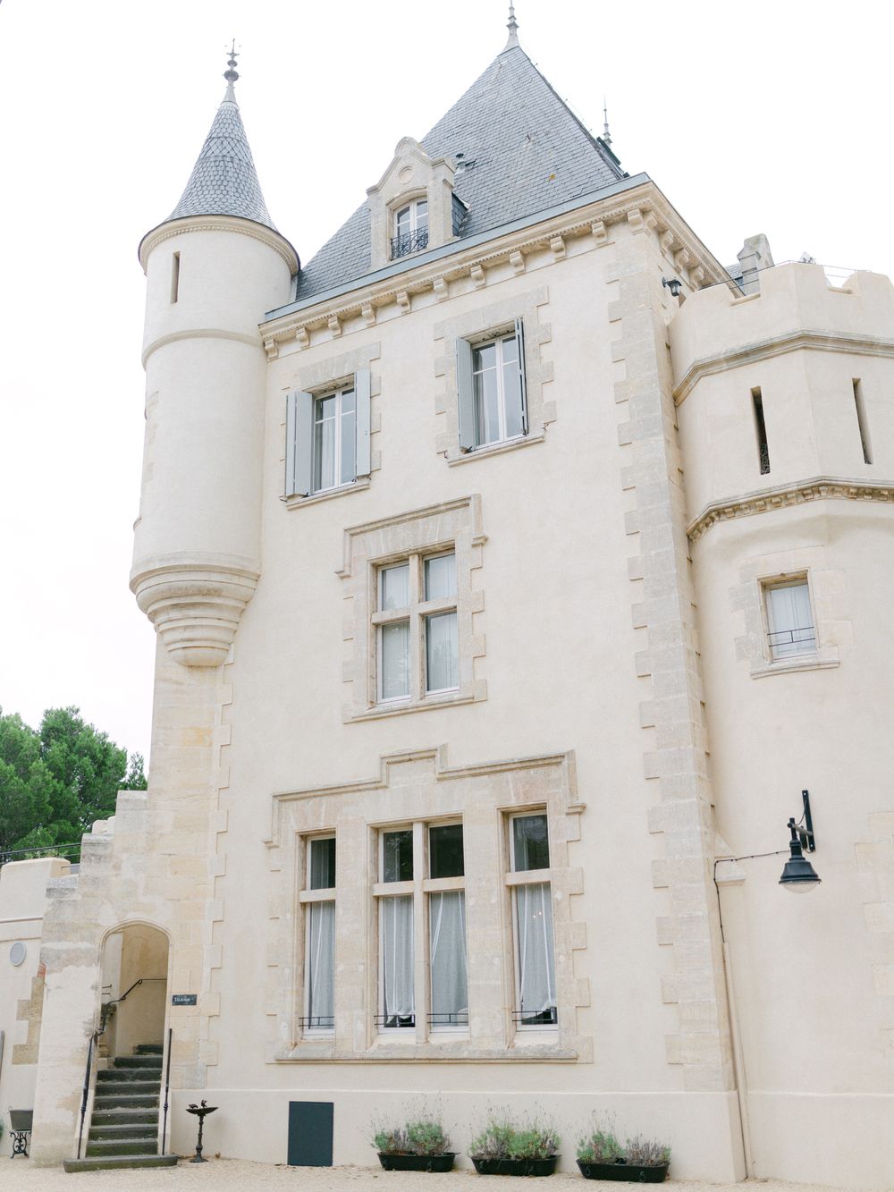 Elegant French chateau with turrets and classic architectural details in cream stone.