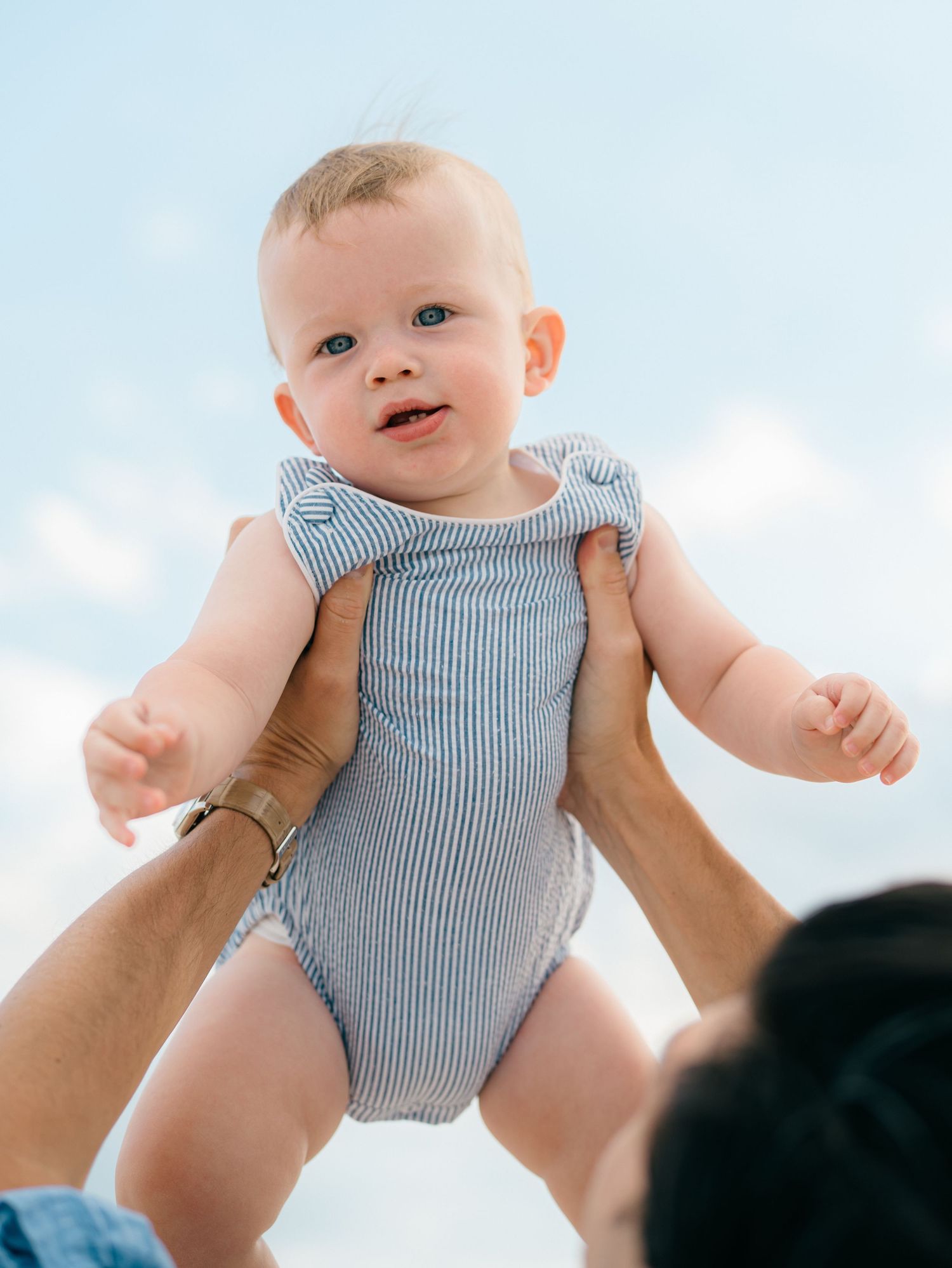 a close up of a toddler in the air while lauren marie photograph photographs the moment.