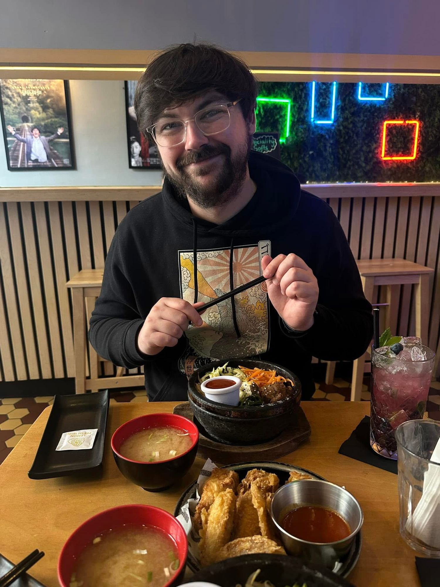 Calvin Ferries smiling with a bowl of Korean food