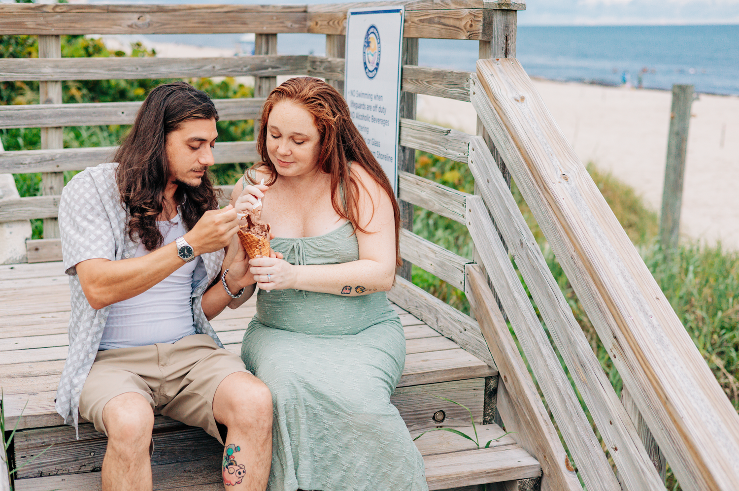 Lake Worth maternity photographer capturing an expecting couple sharing ice cream during their Lake Worth Beach maternity session.