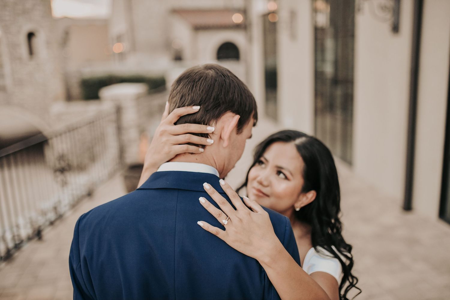 Elegant engagement portrait with European-inspired architecture creating a timeless backdrop