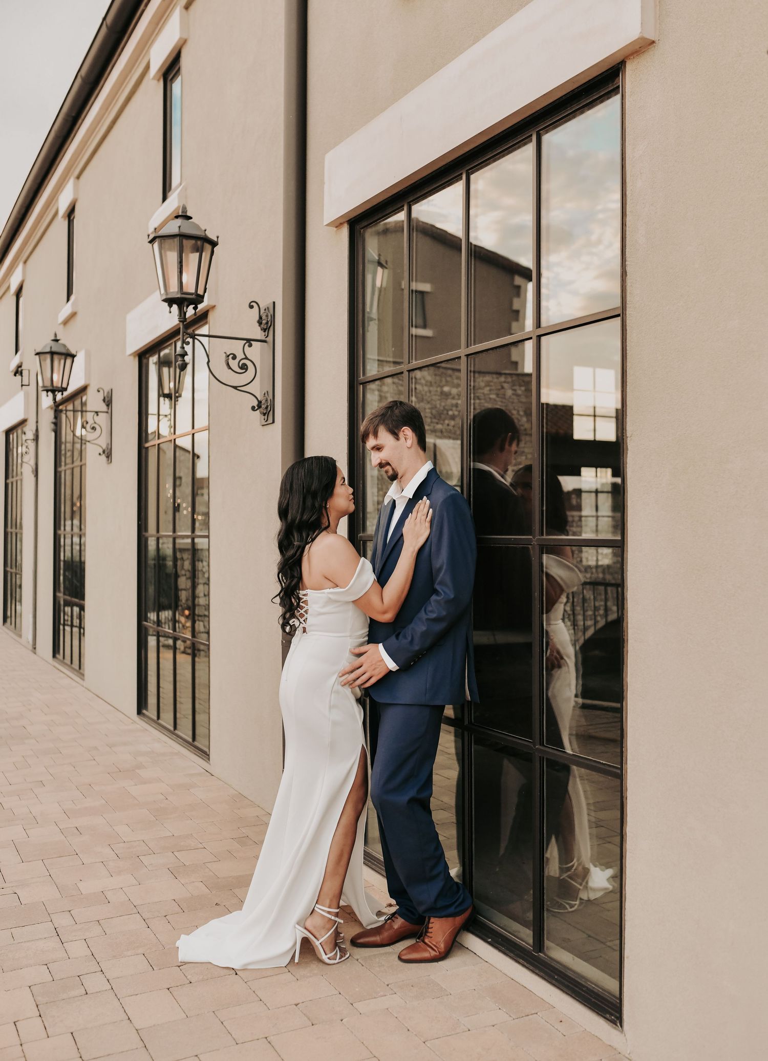 Elegant couple posing beside the water for romantic Dallas-area engagement photos