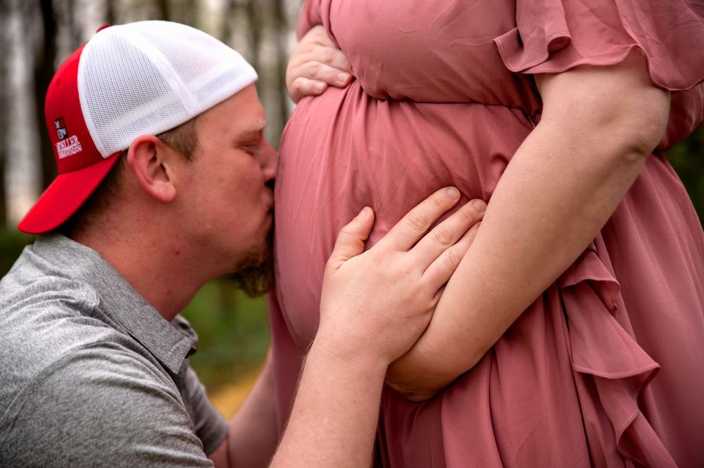 Expectant couple embracing during a maternity photography session in St. Marys, Ohio