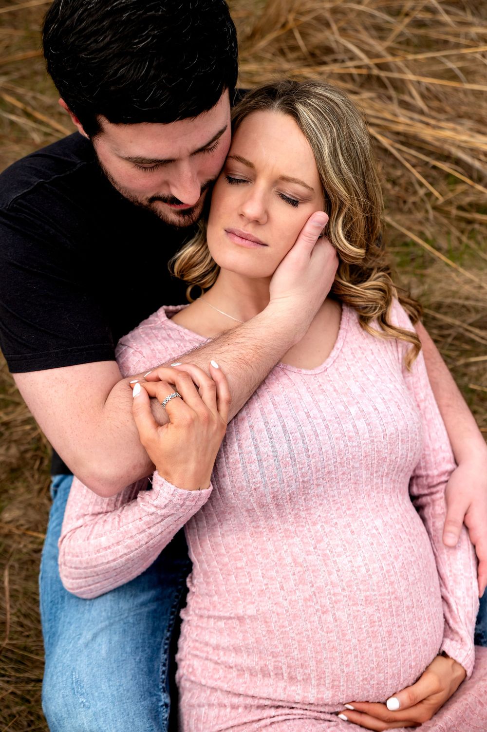 Expectant couple embracing during a maternity photography session in St. Marys, Ohio