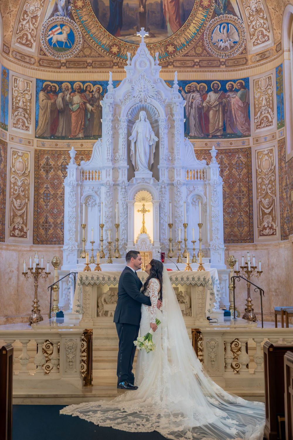 Bride and groom in front of altar at Basilica St. Edwards in Palm Beach