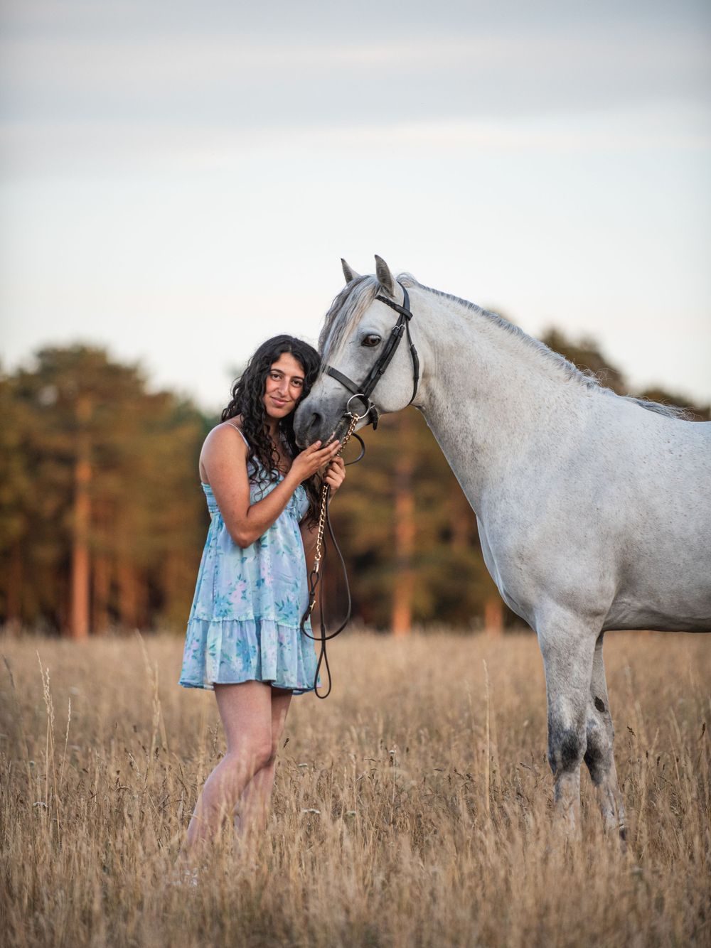 Trainee Equine Vet Rachel with her dapple grey Connemara pony during summer equine portrait photoshoot at Little Lodge Farm in Suffolk