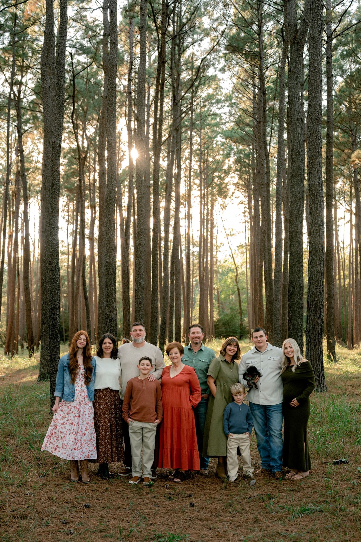 Extended family wearing coordinated fall colors at W.G. Jones State Forest in Conroe, Texas.