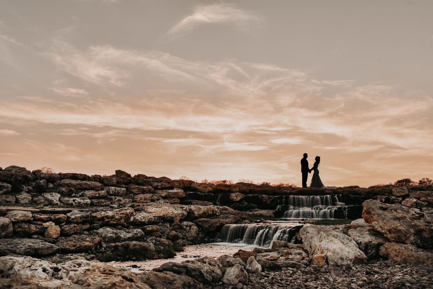 a silhouette of a bride and groom at sunset at lucky spur ranch