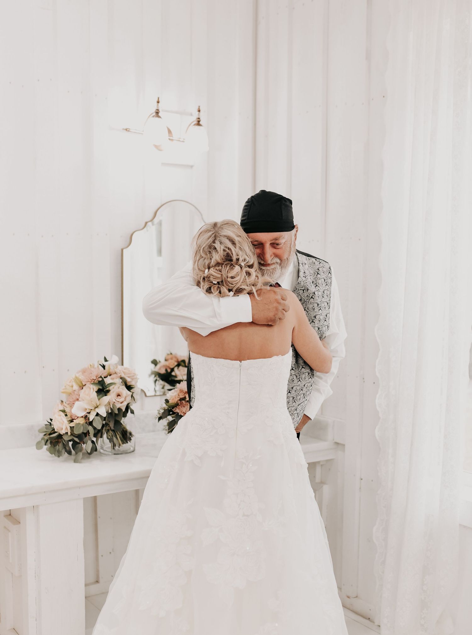 the bride hugs her brother before he walks her down the aisle