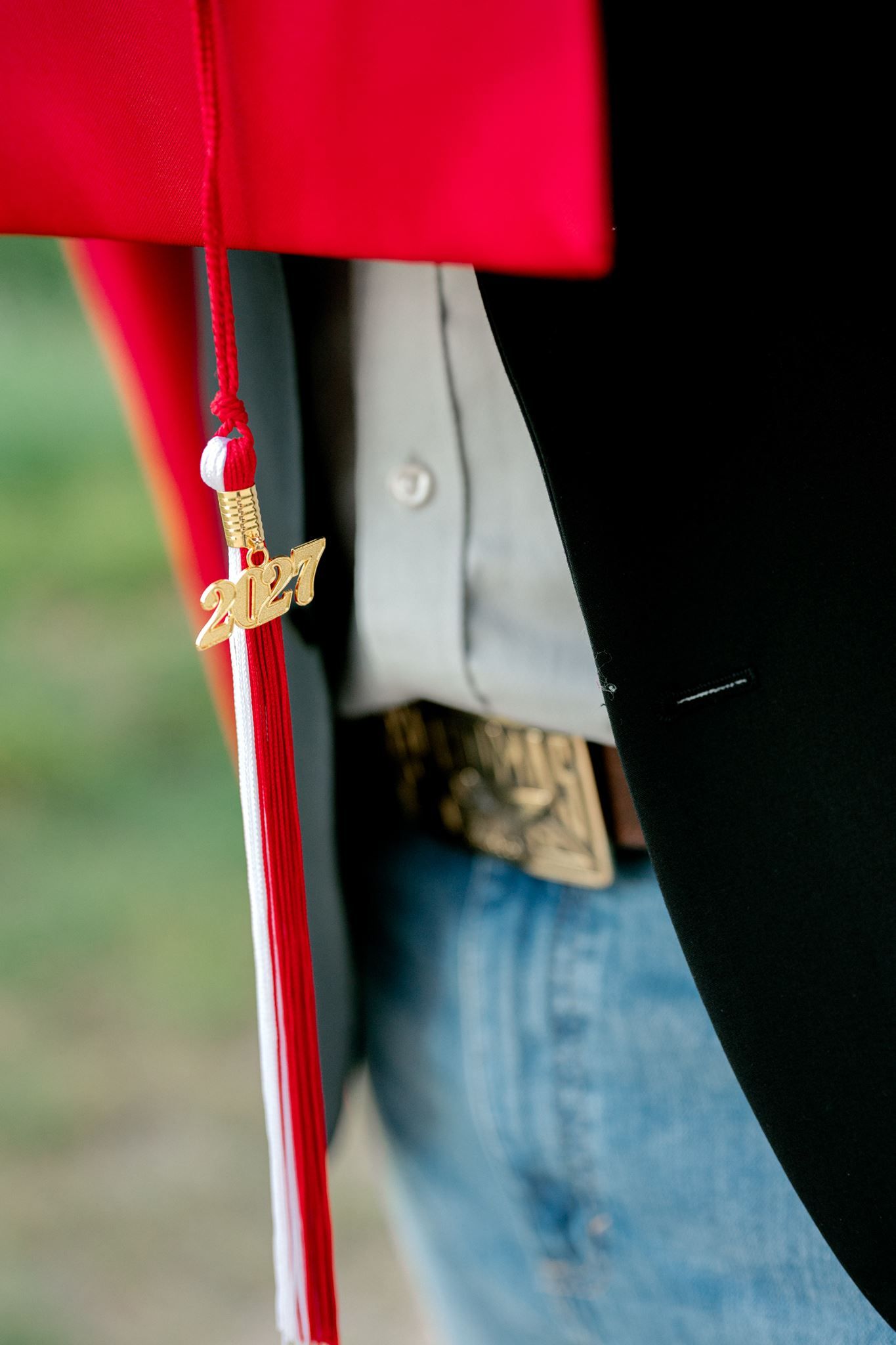 Close up of red graduation cap and 2027 tassle.