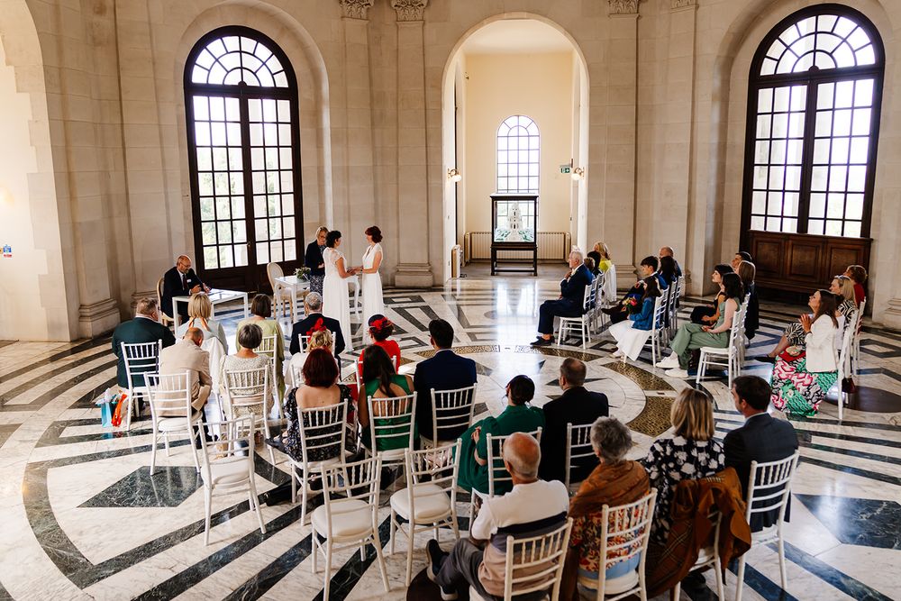 Candid wedding ceremony photos of a same sex wedding beneath the historic domed ceiling at Ashton Memorial